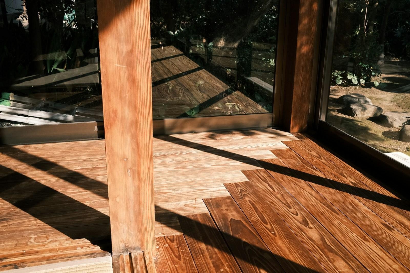 a room with a wooden floor and large windows